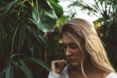 woman near green leafed plants
